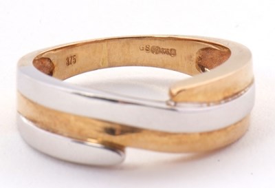 Lot 41 - A 9ct two tone crossover ring, the white and...