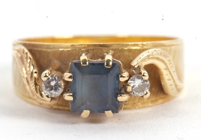 Lot 51 - A sapphire and diamond ring, the central...
