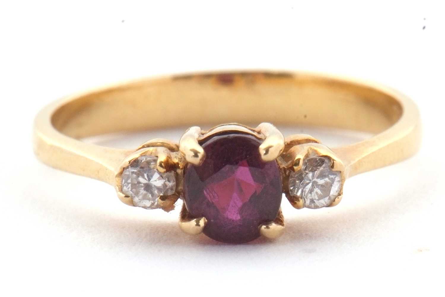 Lot 36 - A ruby and diamond ring, the round ruby set to...