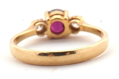 Lot 36 - A ruby and diamond ring, the round ruby set to...