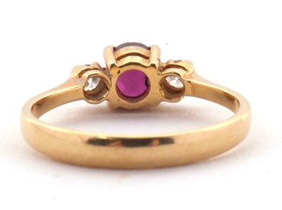 Lot 36 - A ruby and diamond ring, the round ruby set to...