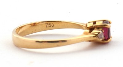 Lot 36 - A ruby and diamond ring, the round ruby set to...