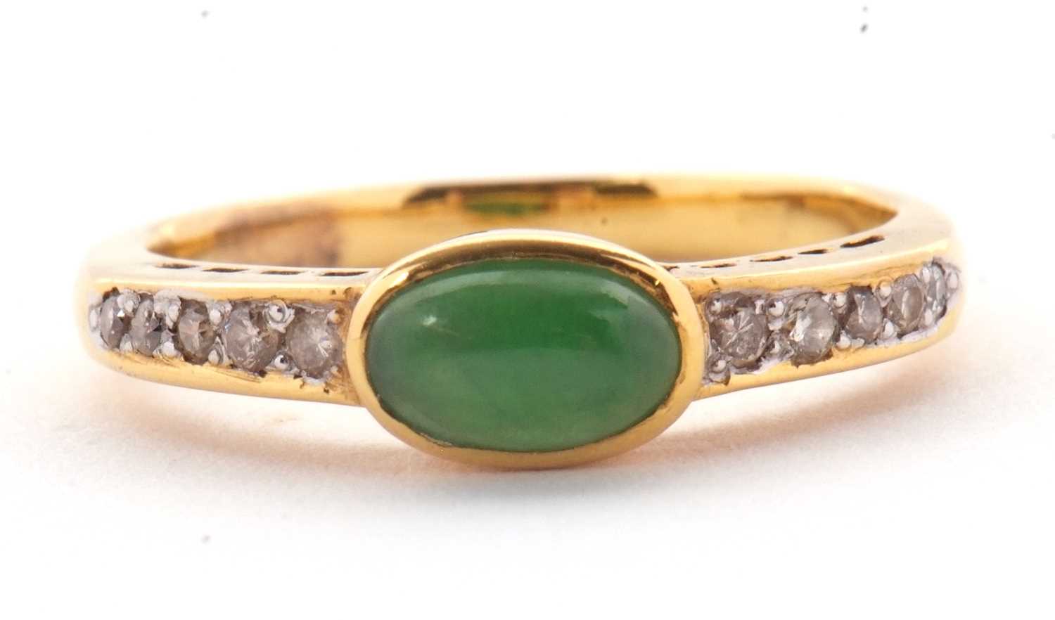 Lot 30 - A jade and diamond ring, the oval collet...