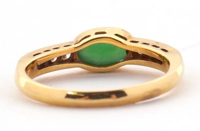 Lot 30 - A jade and diamond ring, the oval collet...