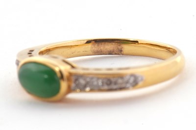 Lot 30 - A jade and diamond ring, the oval collet...