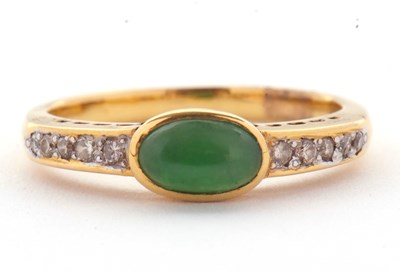Lot 30 - A jade and diamond ring, the oval collet...