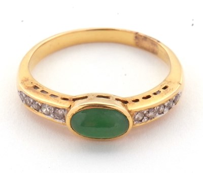 Lot 30 - A jade and diamond ring, the oval collet...