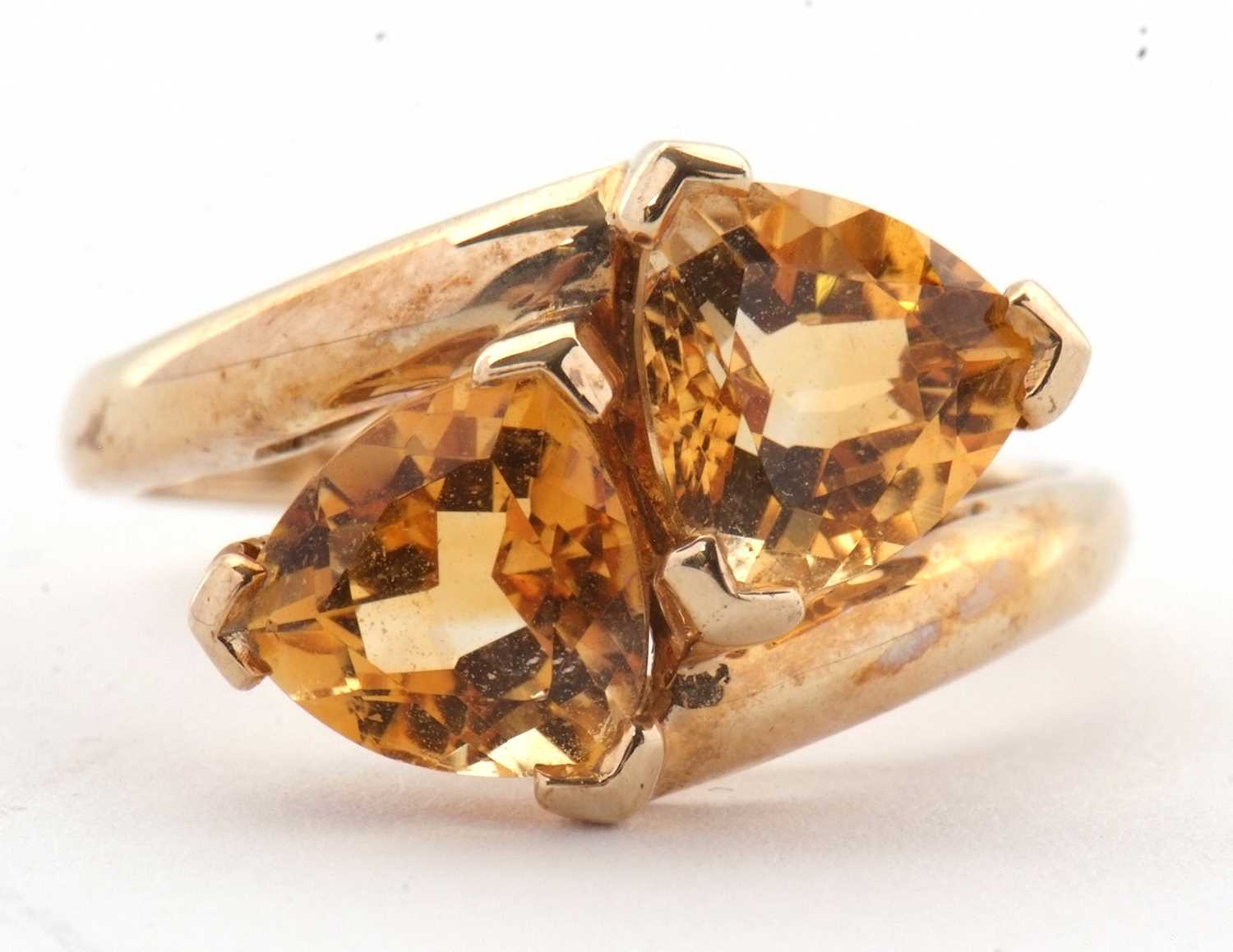 Lot 73 - A 9ct citrine ring, set with two trillion cut...