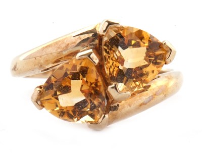 Lot 73 - A 9ct citrine ring, set with two trillion cut...