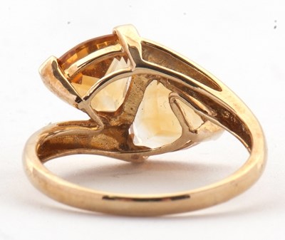Lot 73 - A 9ct citrine ring, set with two trillion cut...