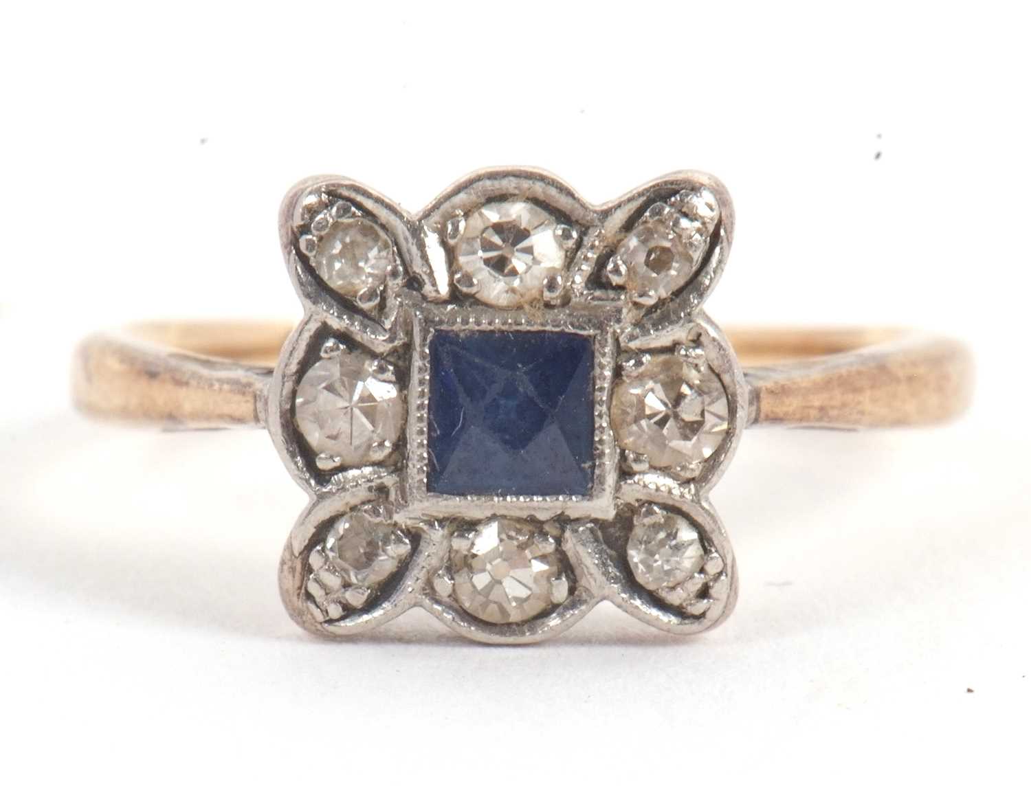 Lot 46 - A sapphire and diamond ring, the central...