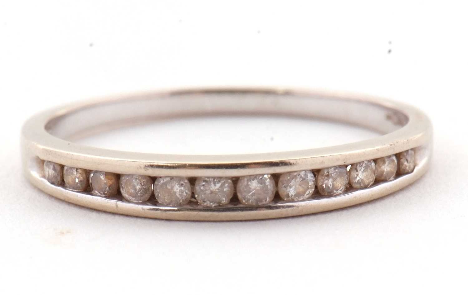 Lot 72 - An 18ct white gold diamond ring, the half hoop...
