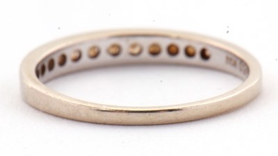 Lot 72 - An 18ct white gold diamond ring, the half hoop...