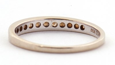 Lot 72 - An 18ct white gold diamond ring, the half hoop...