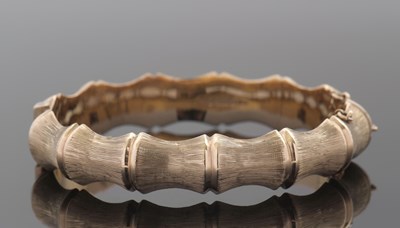 Lot 291 - A 9ct faux bamboo gold bangle, the hinged...