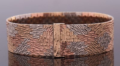 Lot 292 - A 9ct tri-colour gold bracelet, the abstract,...