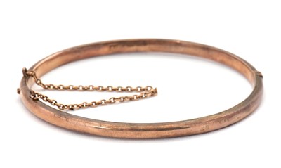 Lot 185 - A 9ct gold bangle, 4mm wide, stamped 9.375 and...