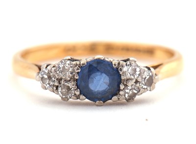 Lot 11 - A 22ct sapphire and diamond ring, the central...