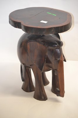 Lot 427 - A 20th Century hardwood stool with elephant...