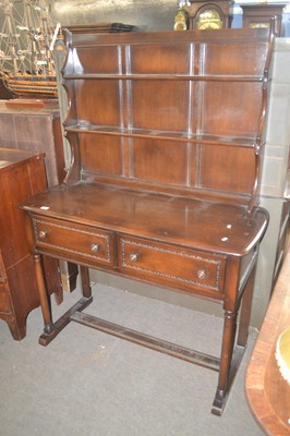 Lot 470 - An Ercol dark elm dresser with two shelf back...