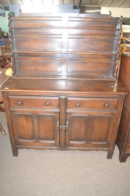 Lot 381 - A dark Ercol dresser with three shelf back...
