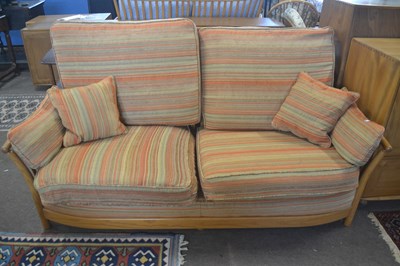 Lot 472 - An Ercol two seater sofa with striped loose...