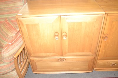 Lot 473 - An Ercol light elm television cabinet with two...