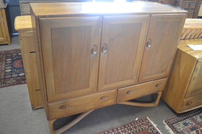 Lot 475 - An unusual Ercol sideboard with three doors...