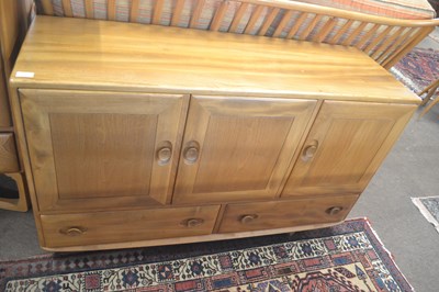 Lot 600 - An Ercol light elm low sideboard with three...