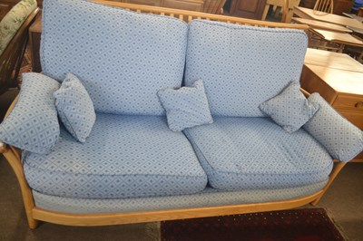 Lot 483 - An Ercol light elm framed sofa with blue loose...
