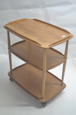 Lot 487 - An Ercol light elm three tier tea trolley,...