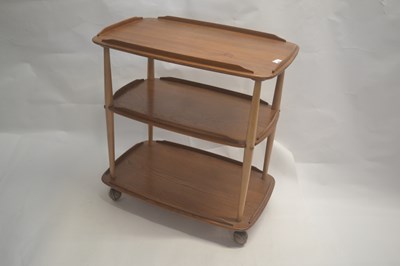 Lot 602 - An Ercol light elm three tier tea trolley,...