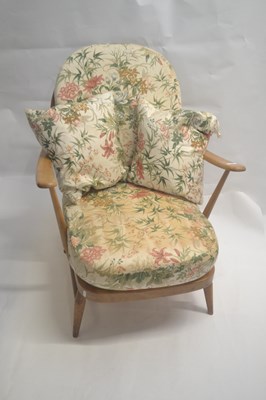 Lot 489 - An Ercol light elm framed stick back armchair...