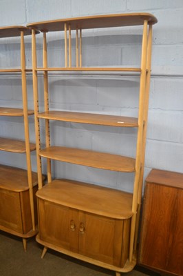 Lot 491 - An Ercol light elm tall adjustable shelf unit...