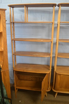 Lot 492 - An Ercol light elm tall adjustable shelf unit...