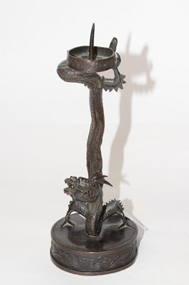 Lot 310 - A Chinese metal candlestick shaped as a dragon...