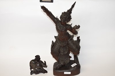 Lot 212 - A large carved wooden figure of a Hindu deity...