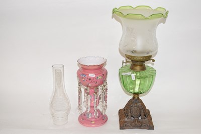 Lot 267 - A late 19th Century oil lamp with green glass...