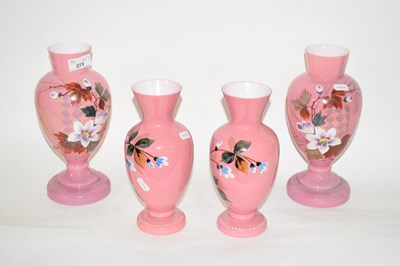 Lot 273 - Two pairs of pink glass vases, painted with...