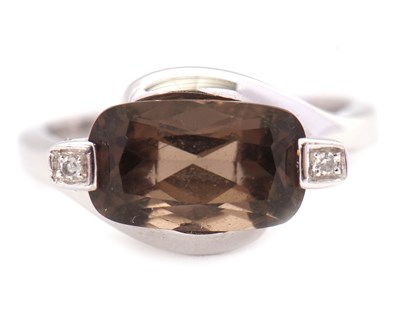 Lot 79 - A 9ct smokey quartz and diamond ring, the...