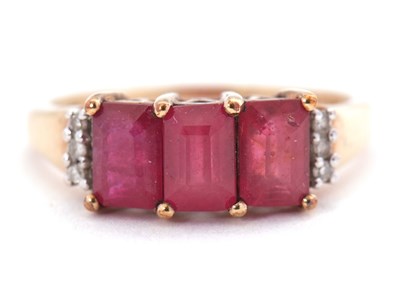 Lot 81 - A 9ct ruby and diamond ring, the three emerald...