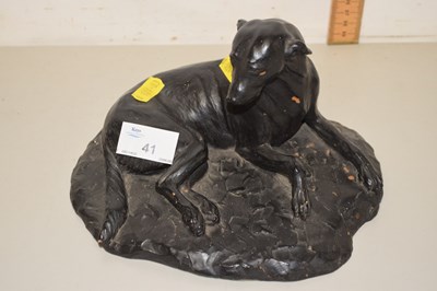 Lot 41 - A painted composition model of a recumbant dog
