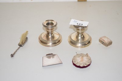 Lot 123 - A pair of small silver mounted loaded dressing...