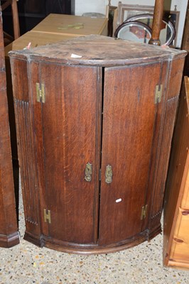 Lot 328 - A Georgian oak wall mounted two door bow front...