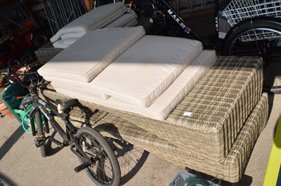 Lot 426 - Two rattan sun loungers together with cushions