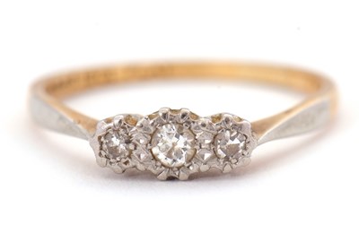 Lot 66 - A diamond ring, set with three graduated...
