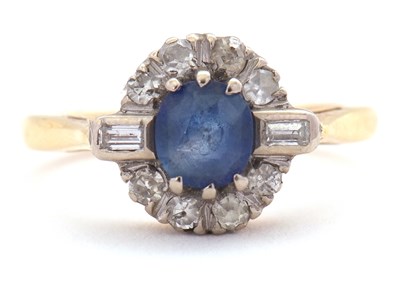 Lot 27 - A sapphire and diamond ring, the central round...