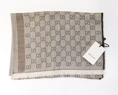 Lot 139 - A Gucci scarf, the wool and silk blend beige...