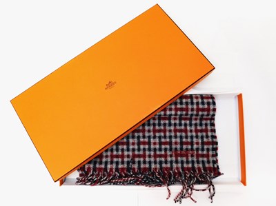 Lot 137 - An Hermes Ecossais cashmere scarf, in red,...
