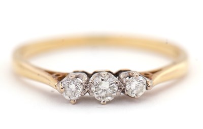 Lot 16 - An 18ct three stone diamond ring, the three...